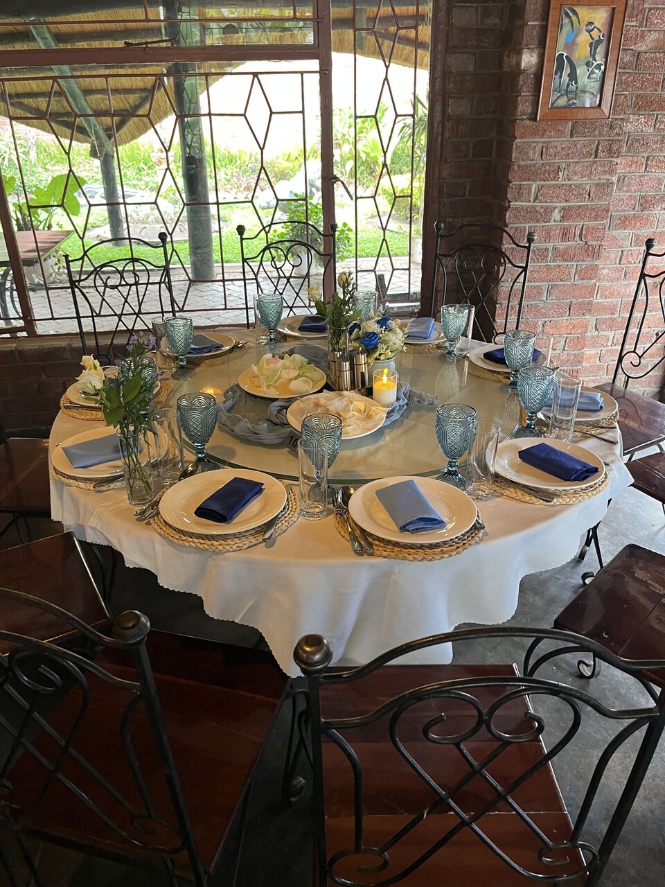 Round table setting in blue and gold with layered glassware