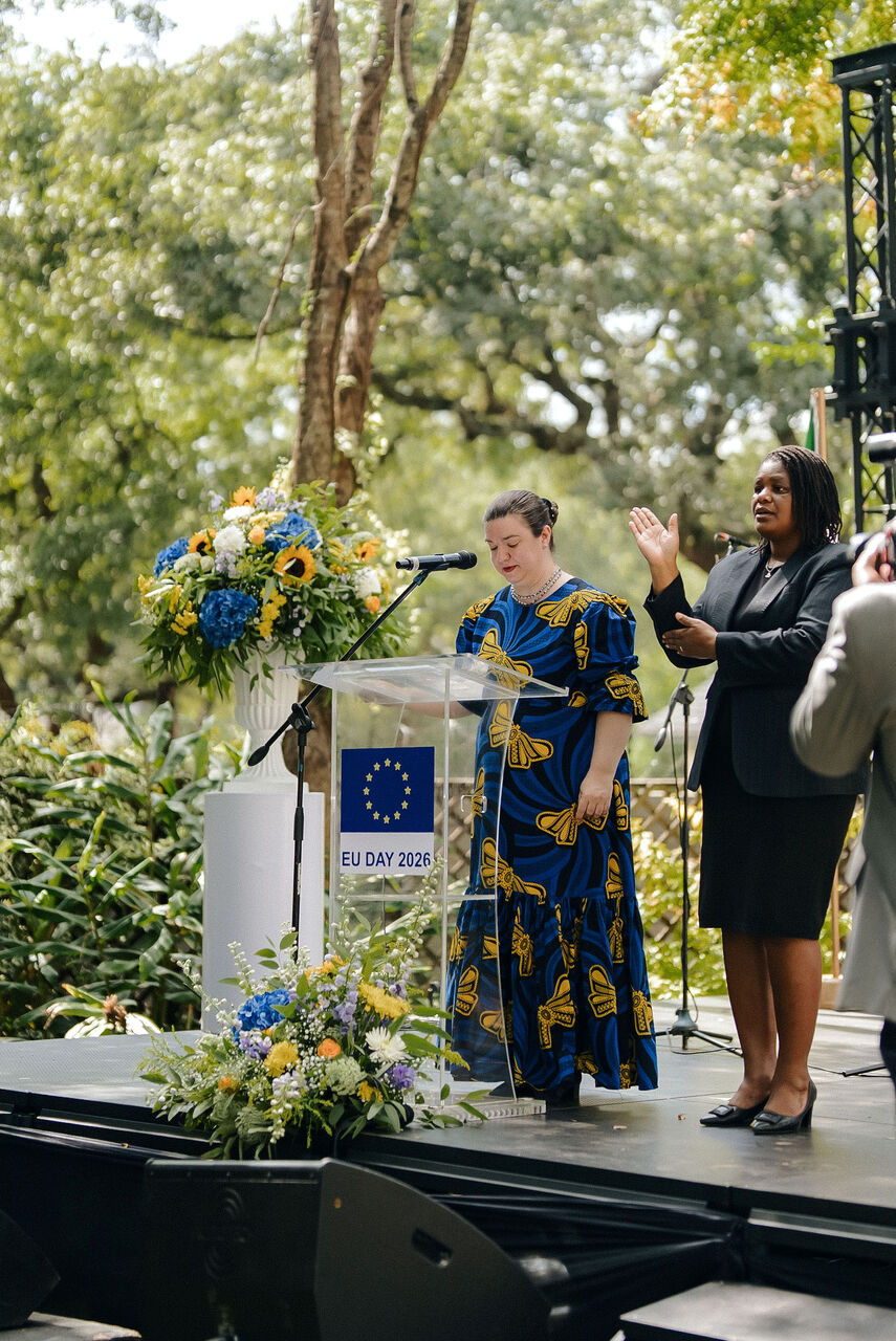 Stage and screen dressed with floral installations at an outdoor reception