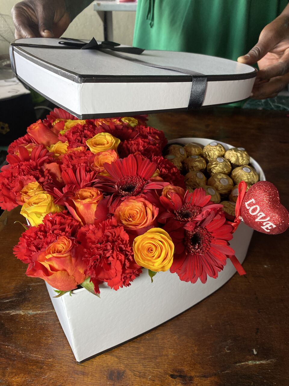 Presentation box of red and orange gerberas and roses