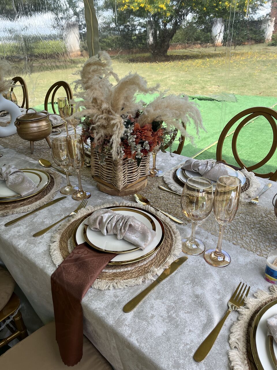Gold and ivory tablescape with pampas centrepiece and layered glassware