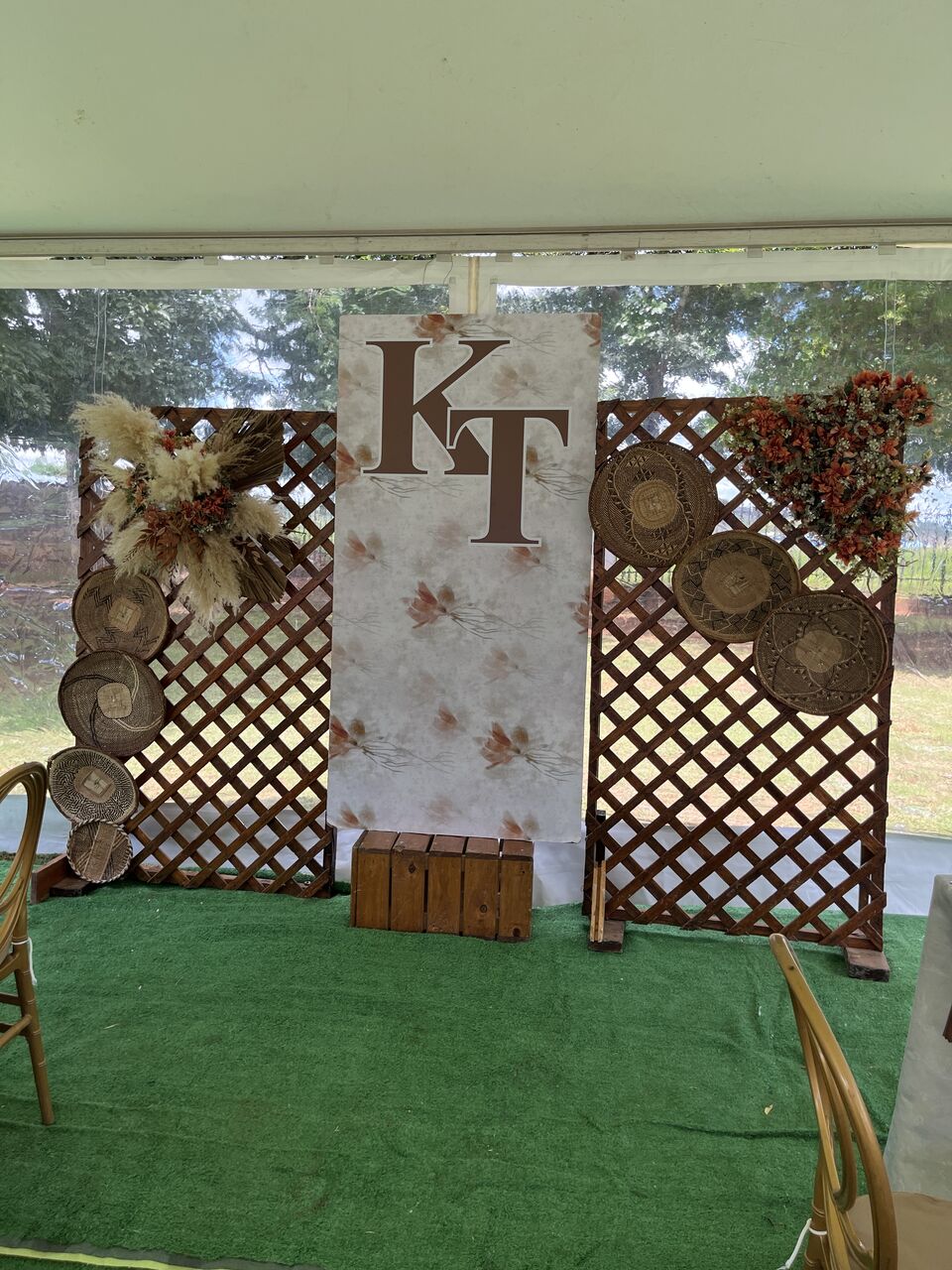 Monogrammed backdrop with lattice screens and dried floral styling